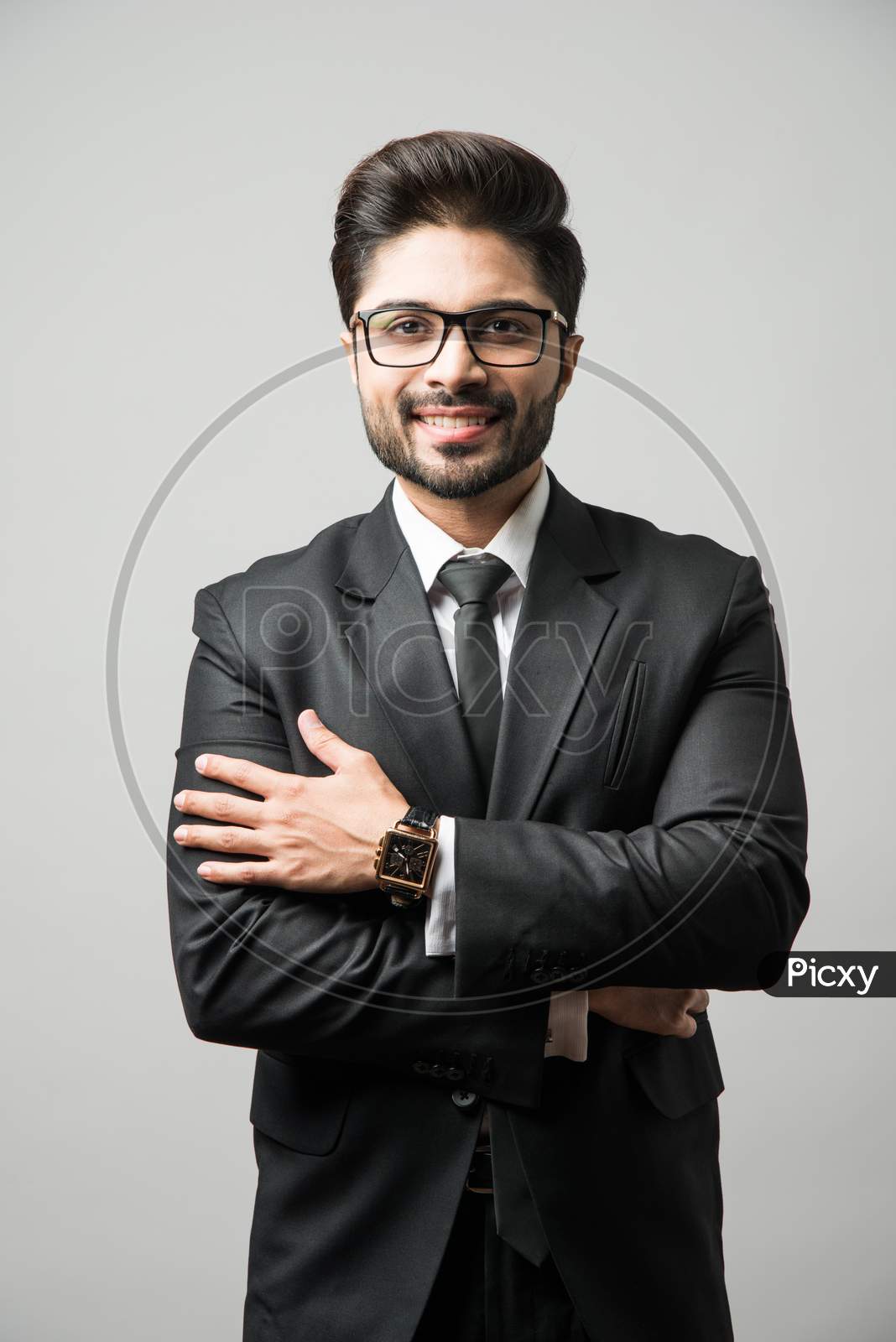 Portrait of Indian Male businessman standing over white background