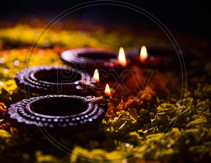 Diwali Diya on Flower Rangoli, selective focus