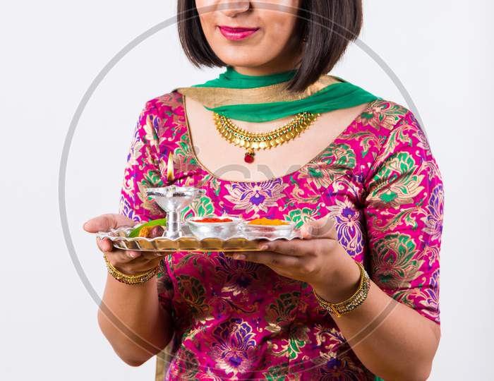 Girl Holding pooja thali / plate
