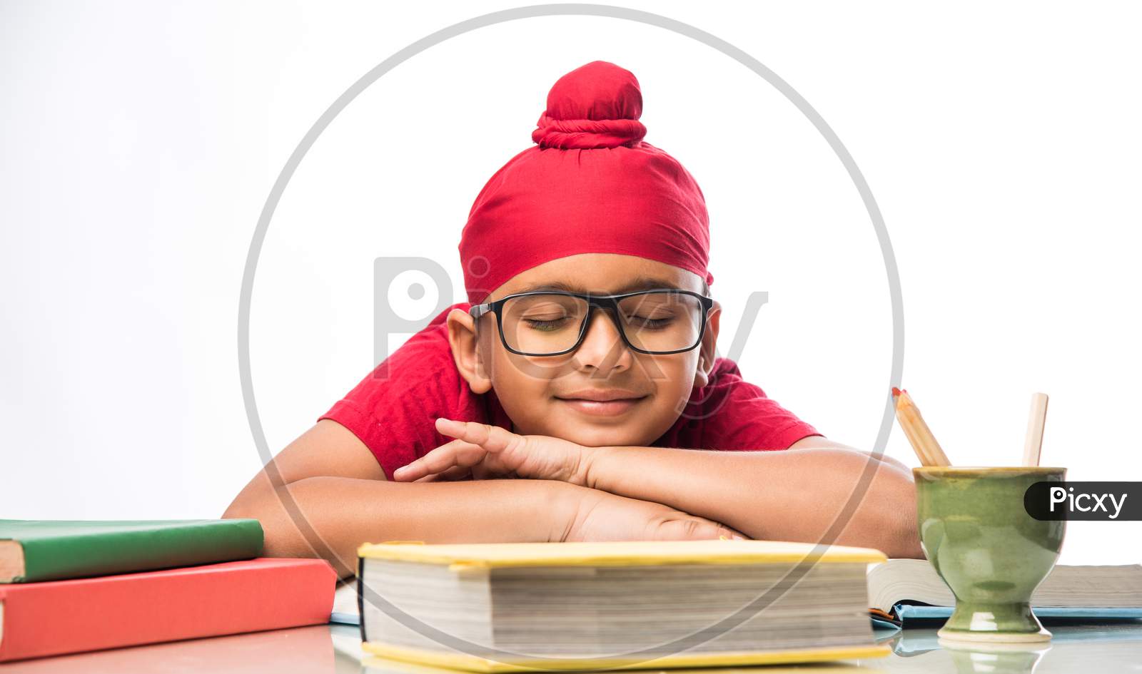 Indian Sikh/punjabi little boy studying with books at study table