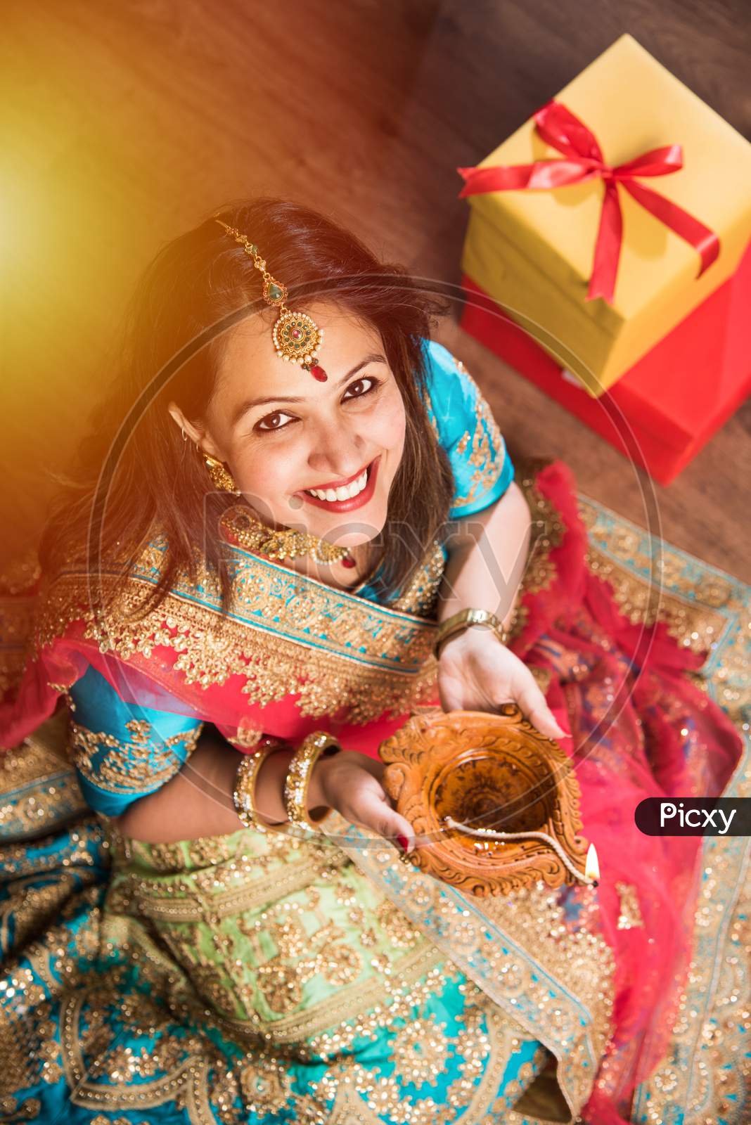 beautiful indian girl holding diya on diwali festival night, top view.selective focus