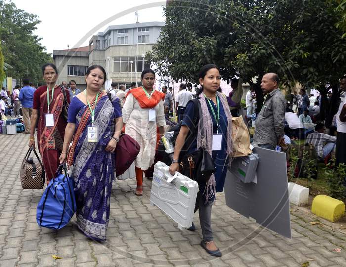 Women Polling officials leave after collecting Electronic Voting Machines (EVM)