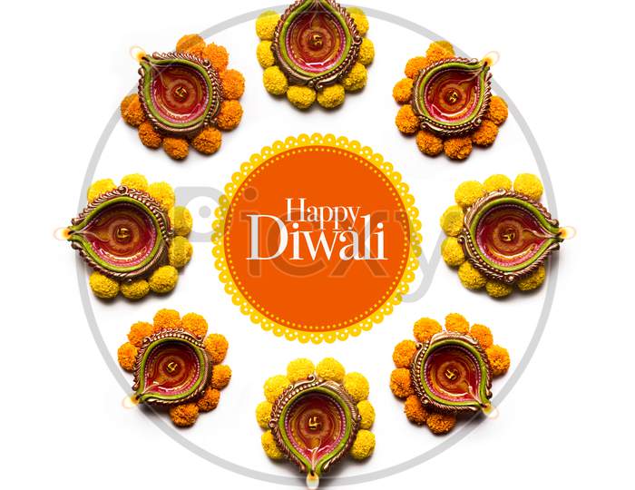 happy Diwali Rangoli made using Diya and flowers