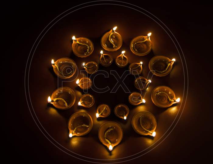 Diwali diyas at night with bokeh of lighting series