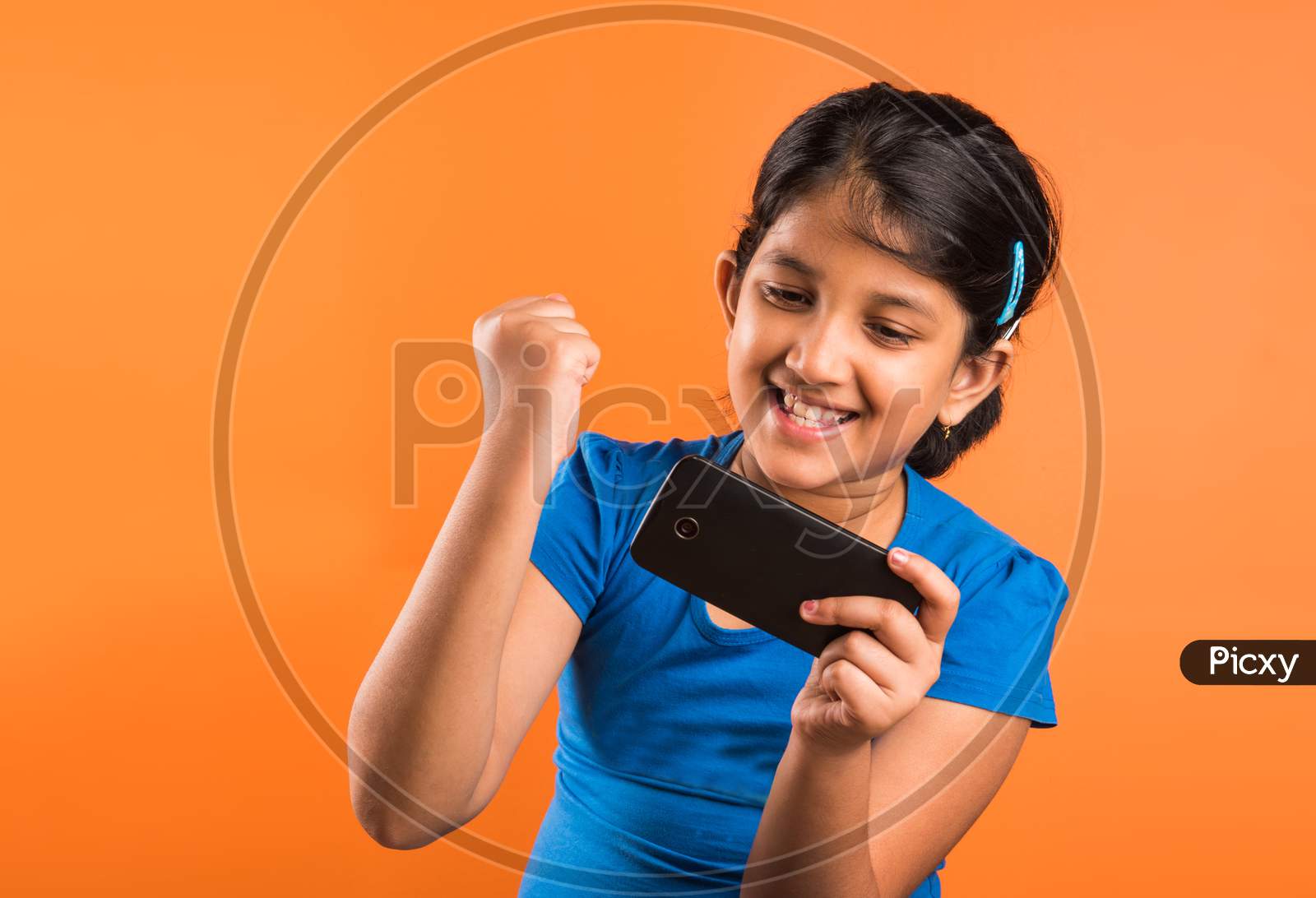 Small Girl using smartphone for playing game or taking selfie picture