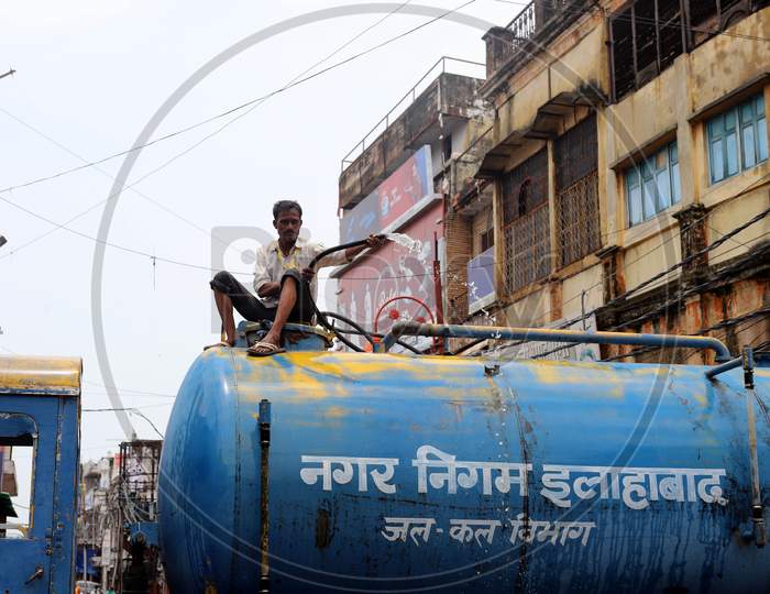 Municipal workers spray disinfectants to sanitize market during the lockdown in Prayagraj, Uttar Pradesh on Jul 11, 2020