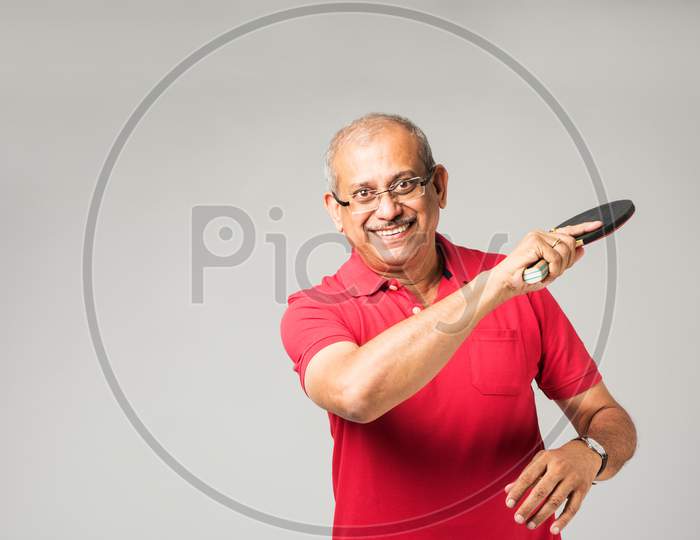 Senior indian man playing table tennis