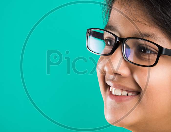 cute little happy Indian girl wearing clear glasses or Spectacles