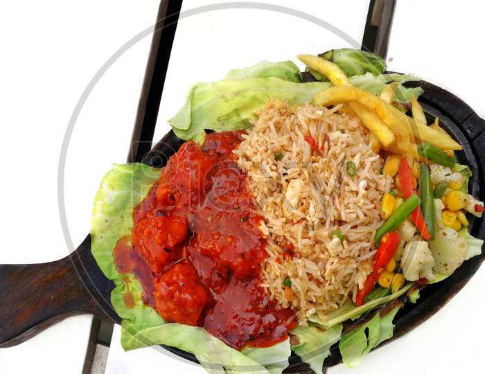 Egg fried rice served with chicken munchurian and veggies platter photography