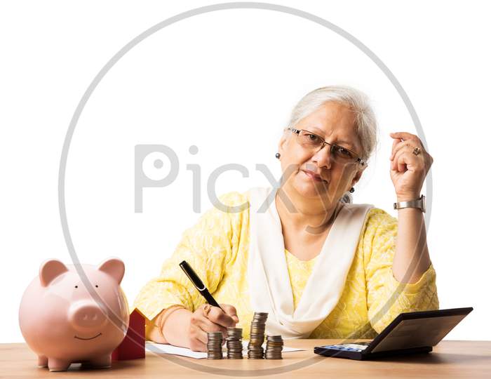Senior woman with money or coins and piggy bank- saving concept