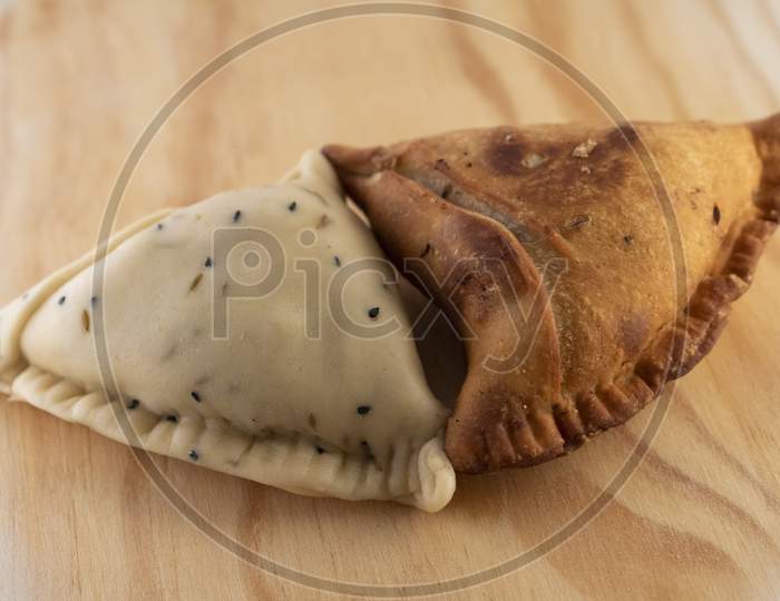 Uncooked and cooked Indian Samosa