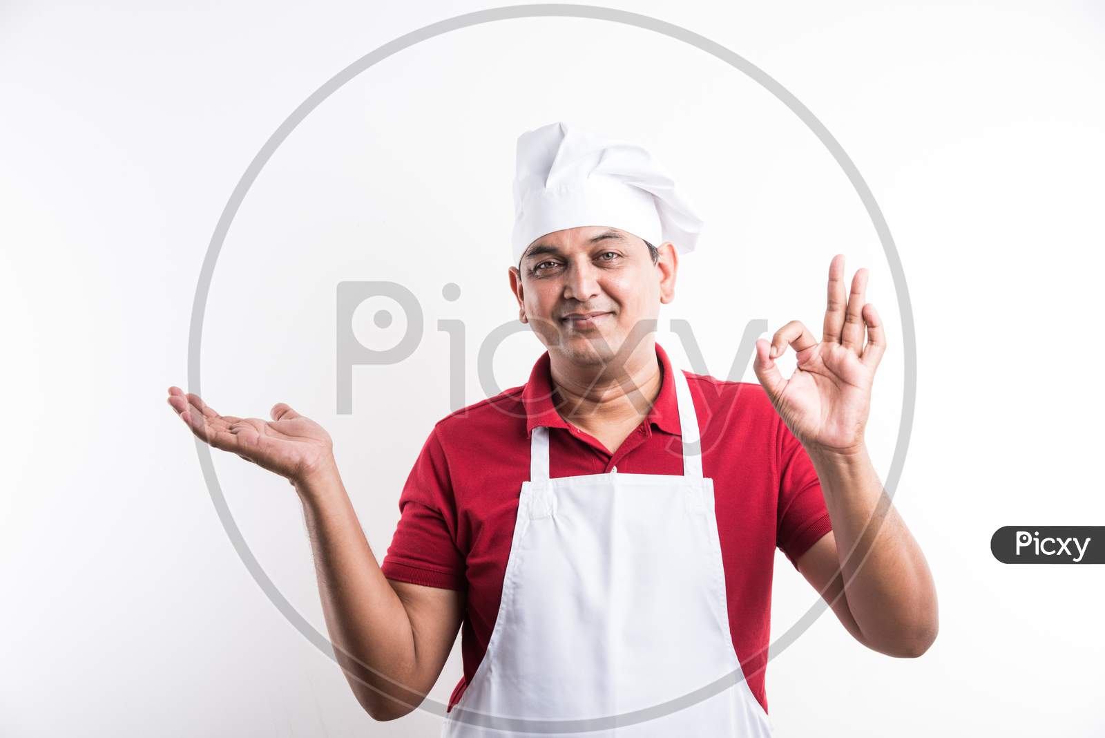 Indian Male Chef / cook in apron and wearing hat