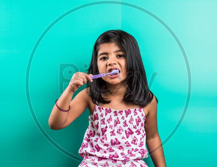 Small girl child brushing teeth