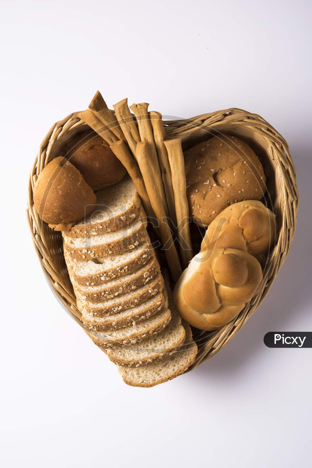 Variety of assorted fresh bread from bakery, served in a basket / tray
