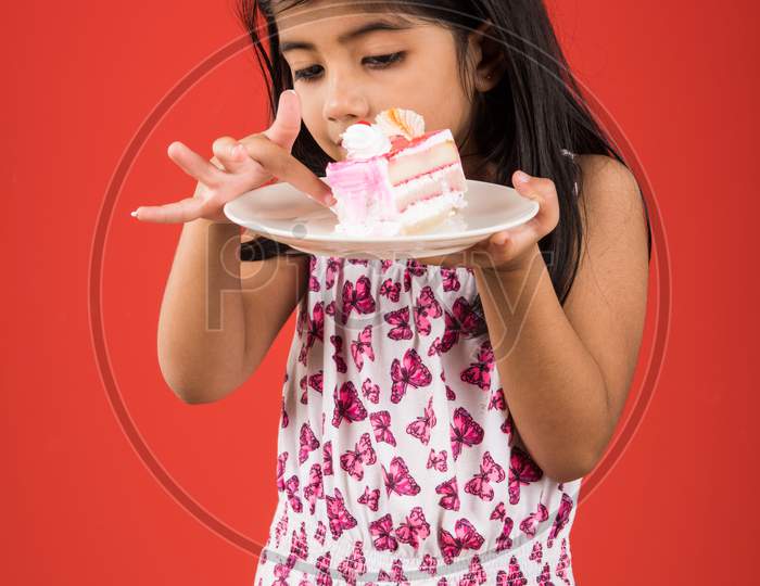 Small Girl eating cake / pastry