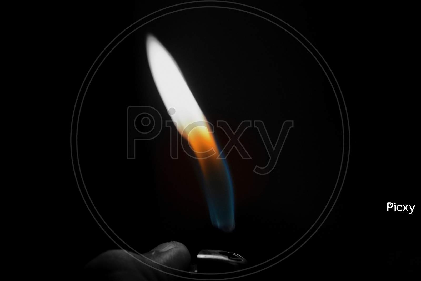 A Hand Lighting Up A Lighter On A Black Background