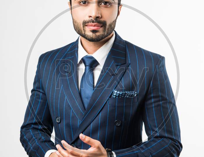 Portrait of Indian Male businessman standing over white background