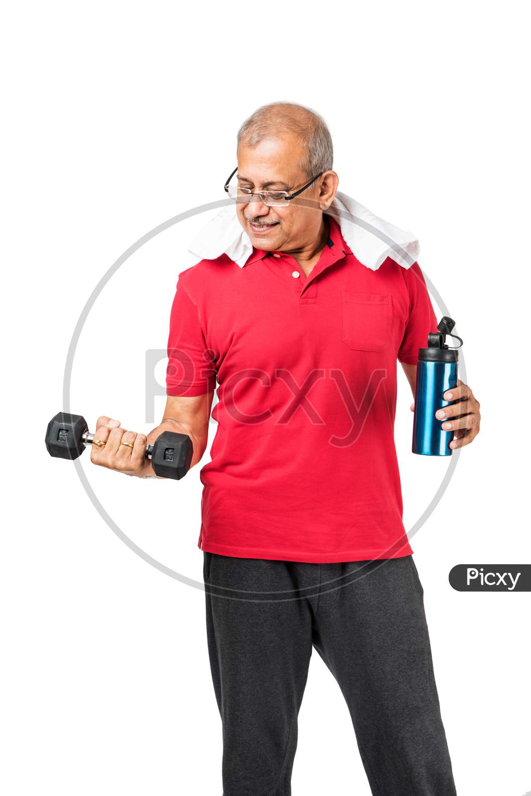 Senior indian man doing weight training / gym