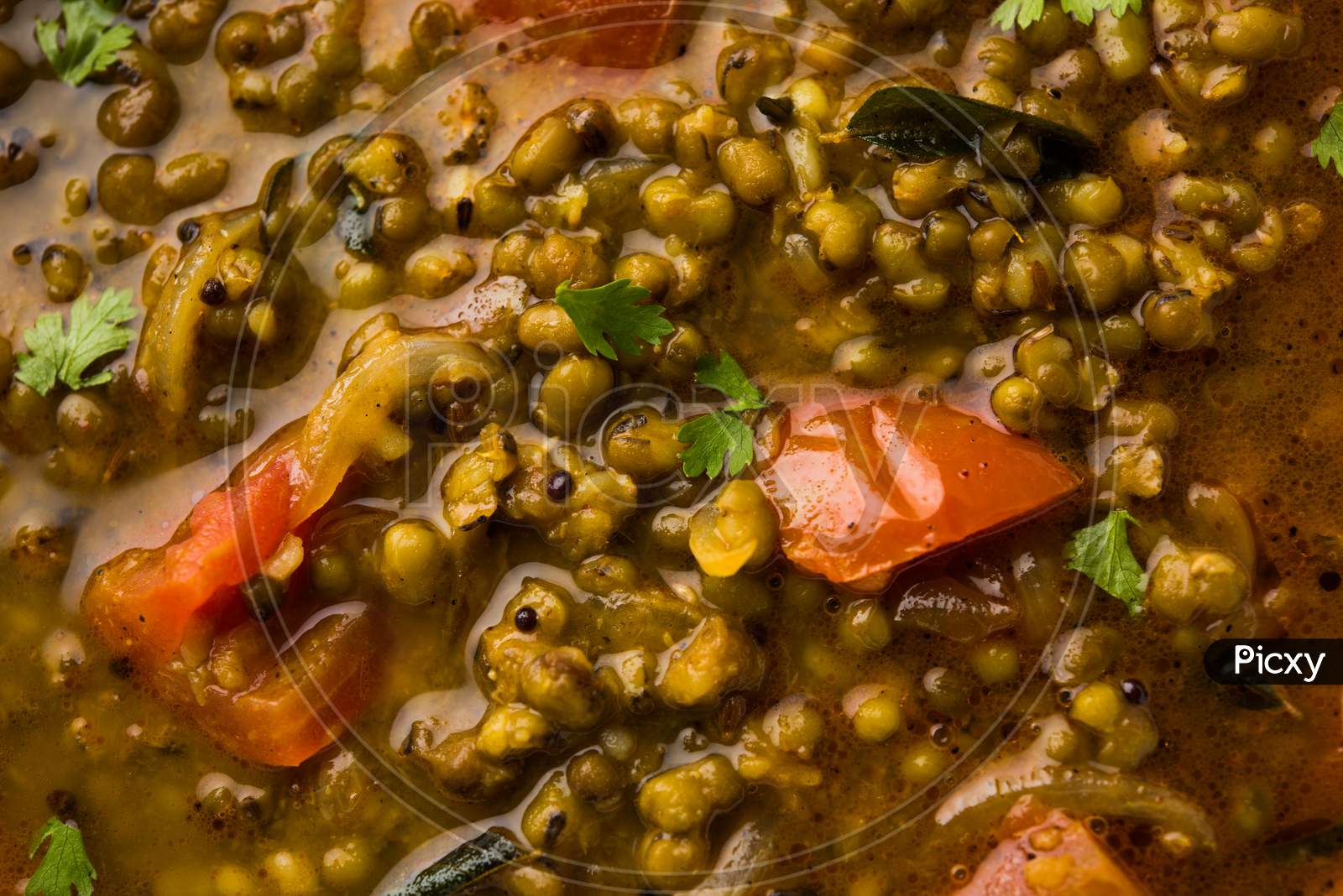 Whole Green Moong Dal fry / Whole Mung bean Tadka served in a bowl. selective focus