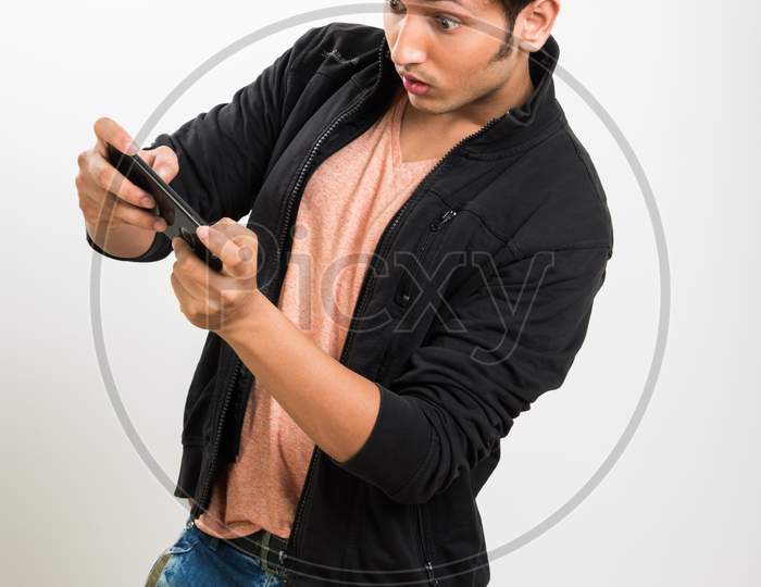 Young man playing game on smartphone