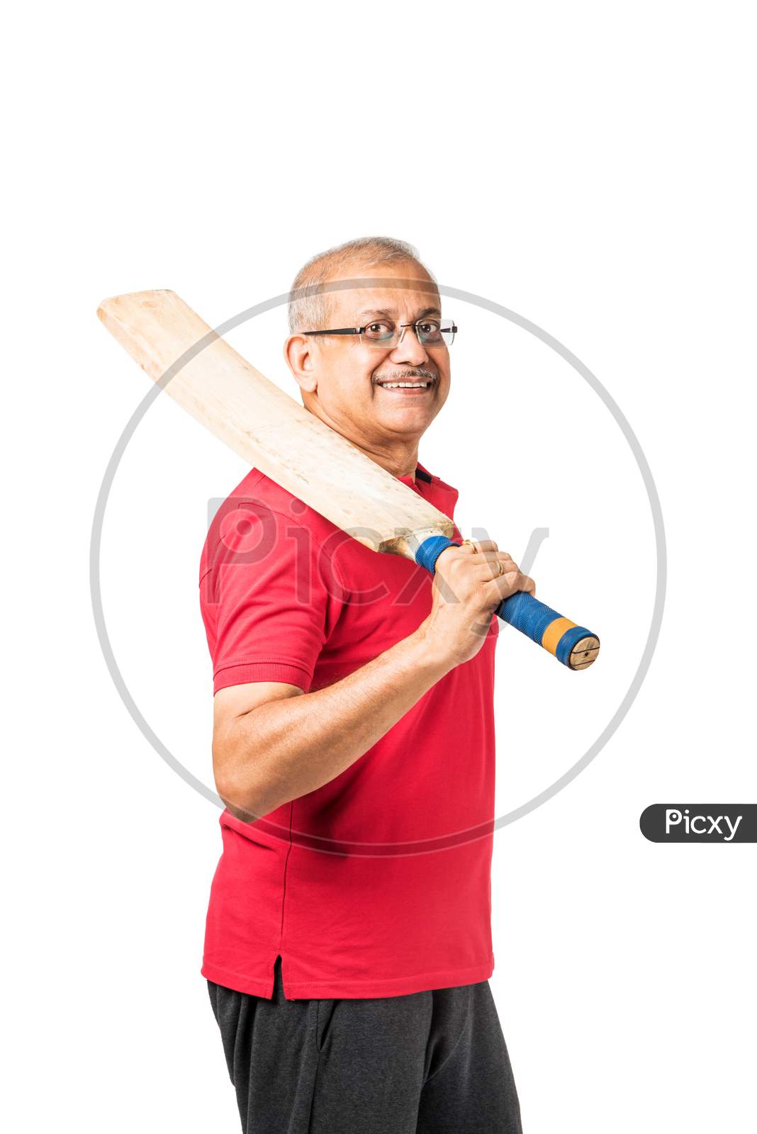 Senior indian man playing cricket with bat
