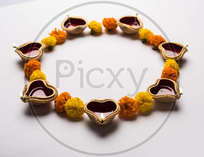 Diya and flower rangoli for Diwali festival
