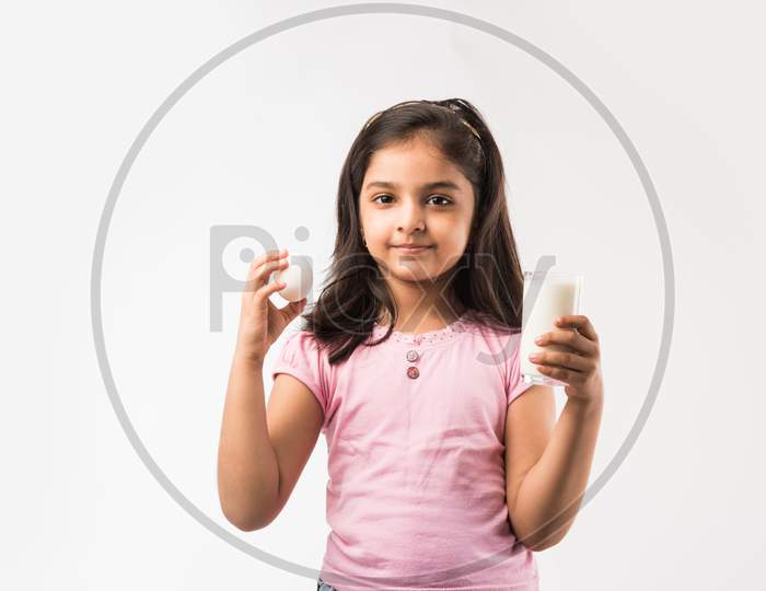 Small Girl eating egg and apple
