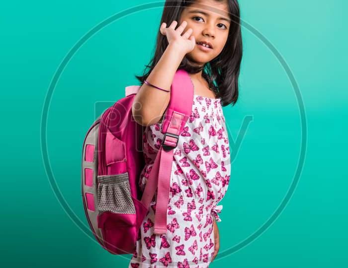 Cute little indian girl with school bag or sack