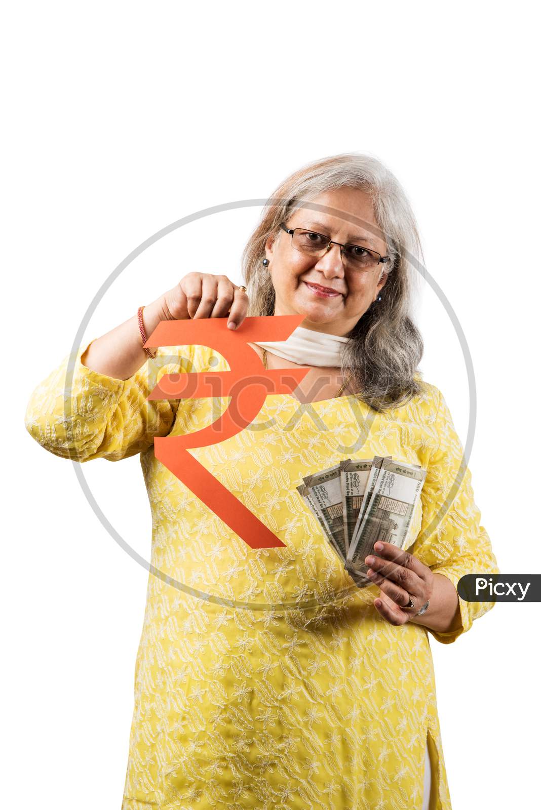 Senior woman holding money fan and piggy bank
