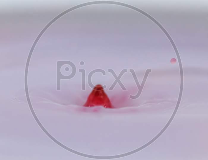 Red Color Water Drop And Splash