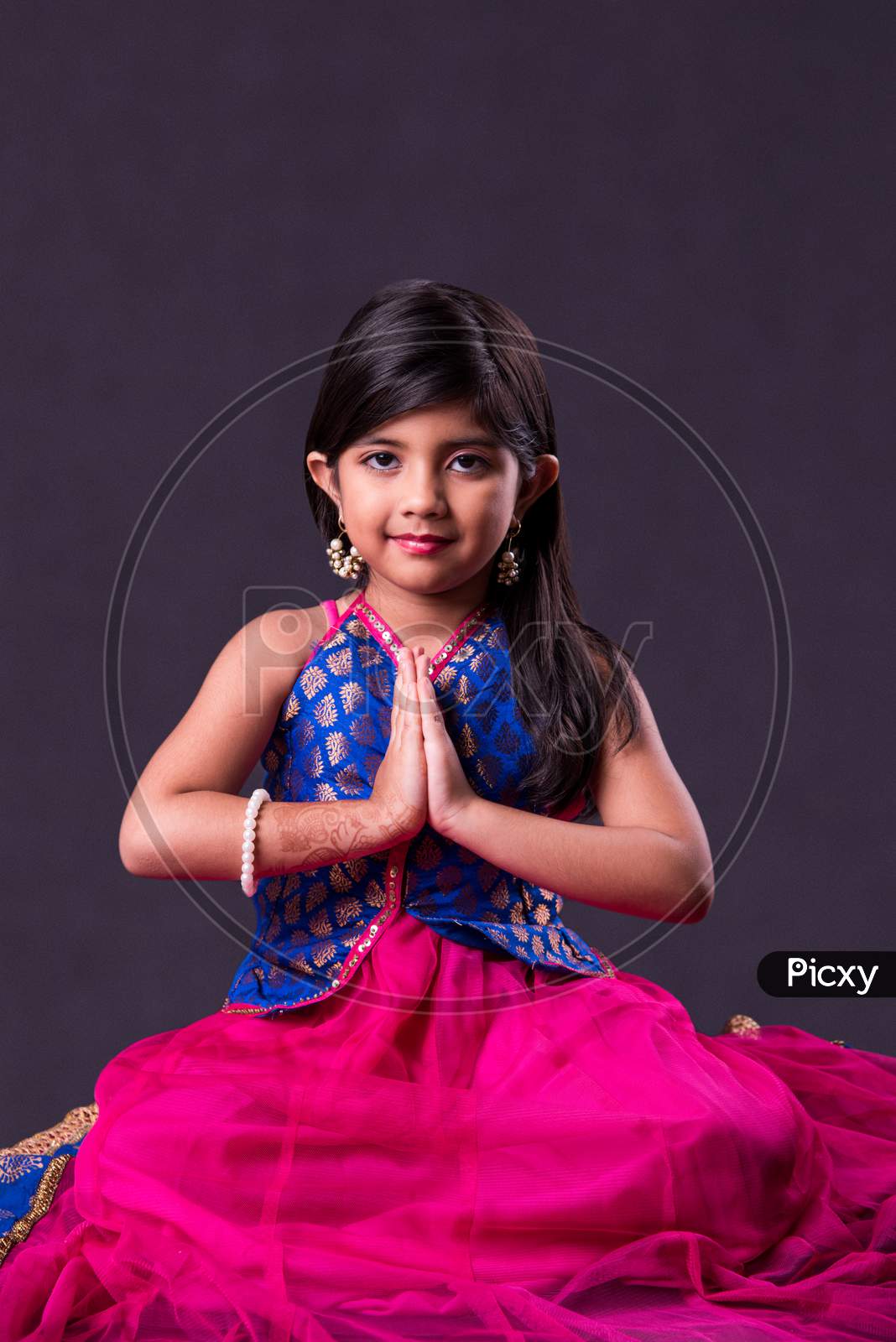 Small girl in namaskara or Prayer pose with both hands folded