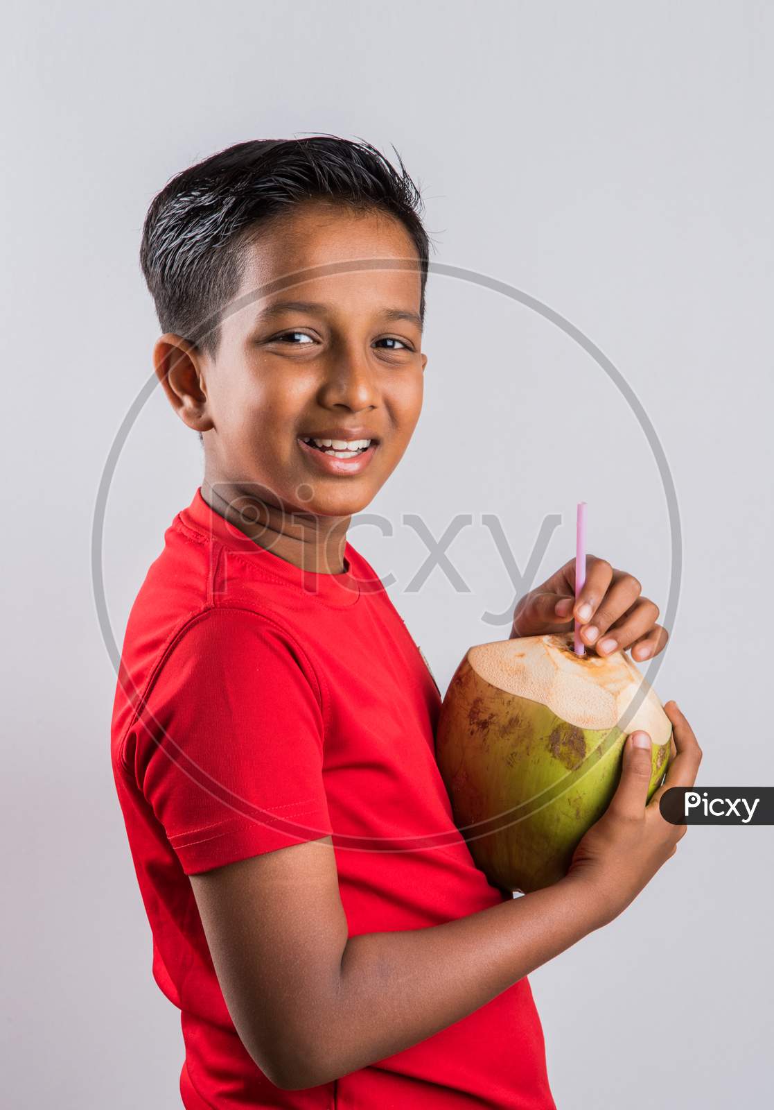 Small boy drinking coconut water / nariyal pani