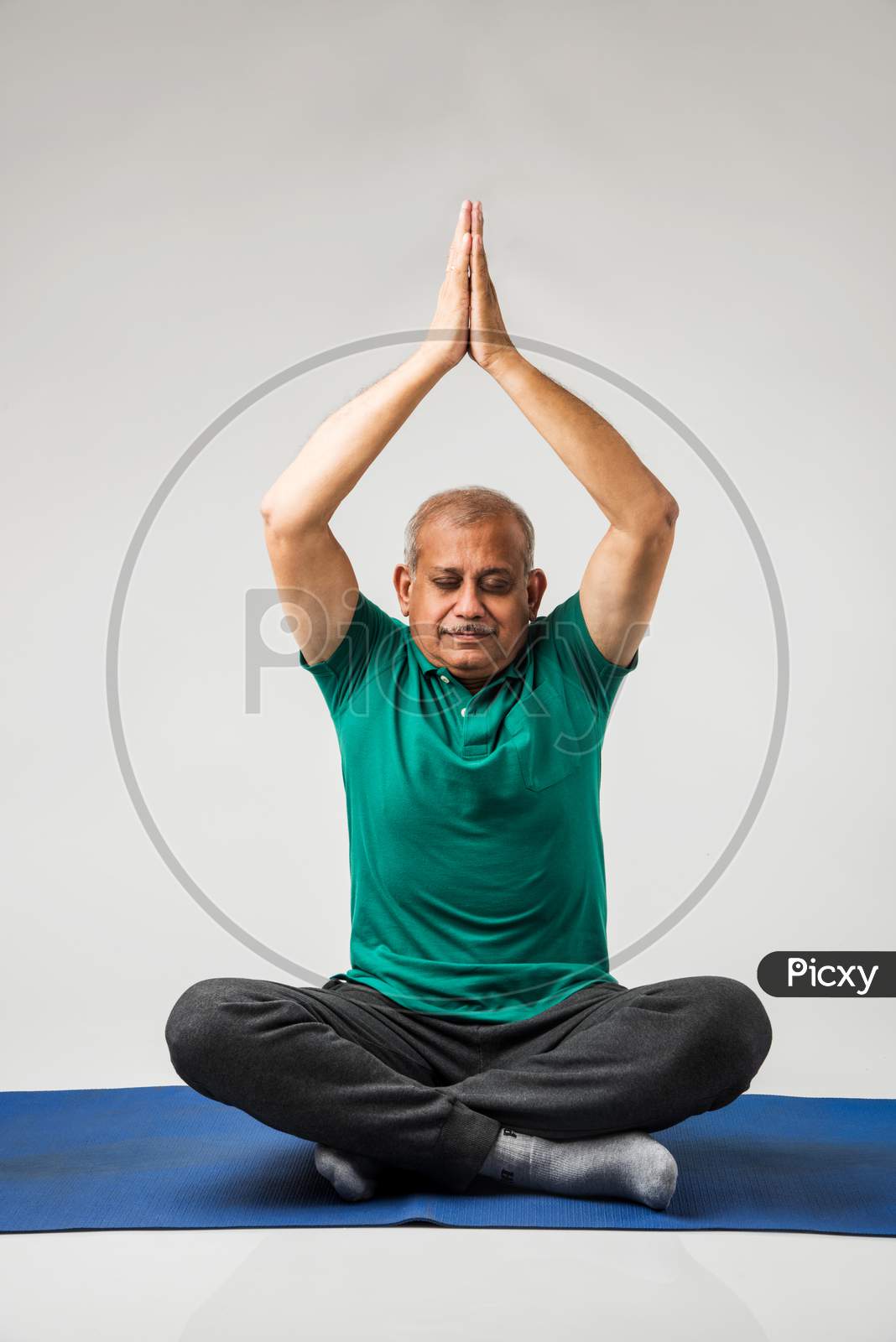 Senior indian man doing yoga or meditation
