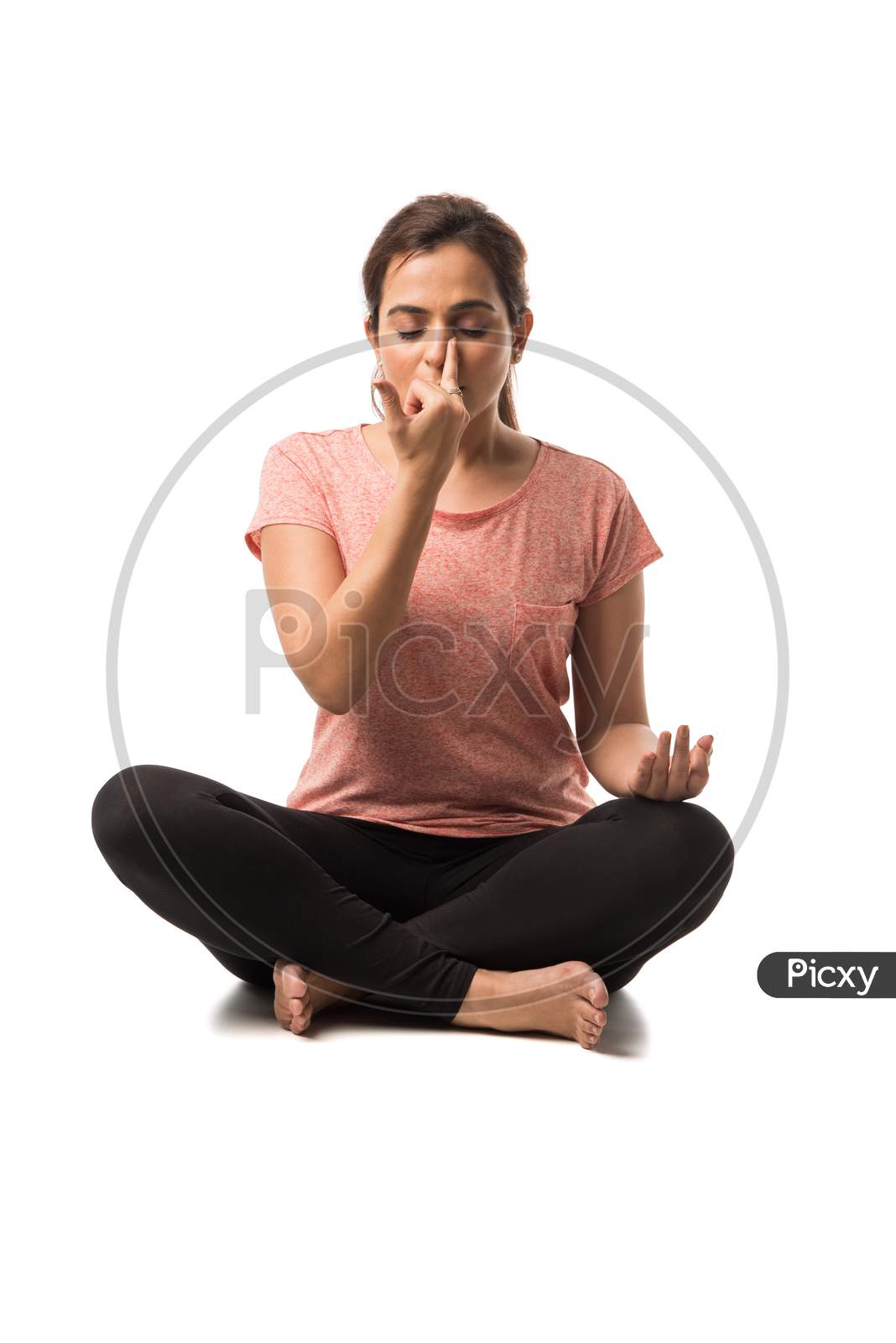 Indian Woman / Girl performing Yoga asana or meditation or dhyan, sitting isolated over white background