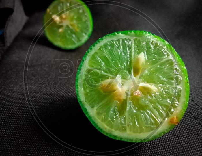 green lemon in black background with selective focus