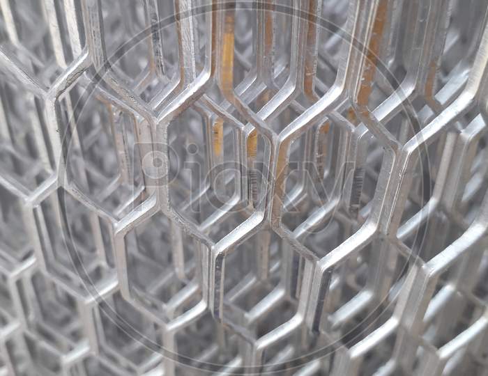 Shiny Aluminium Mesh Roll In A Factory With Partially Blurred