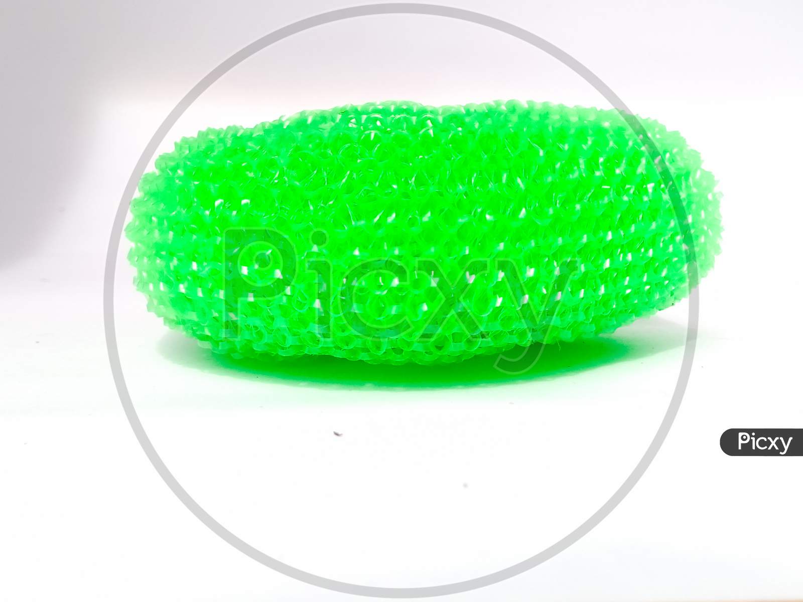 Side View Of A Plastic Dish Wash Scrubber Placed Isolated In A White Background.