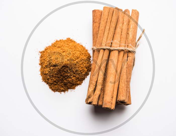 Powder cinnamon and sticks also known as Dalchini or Dalcheenee masala from India, selective focus
