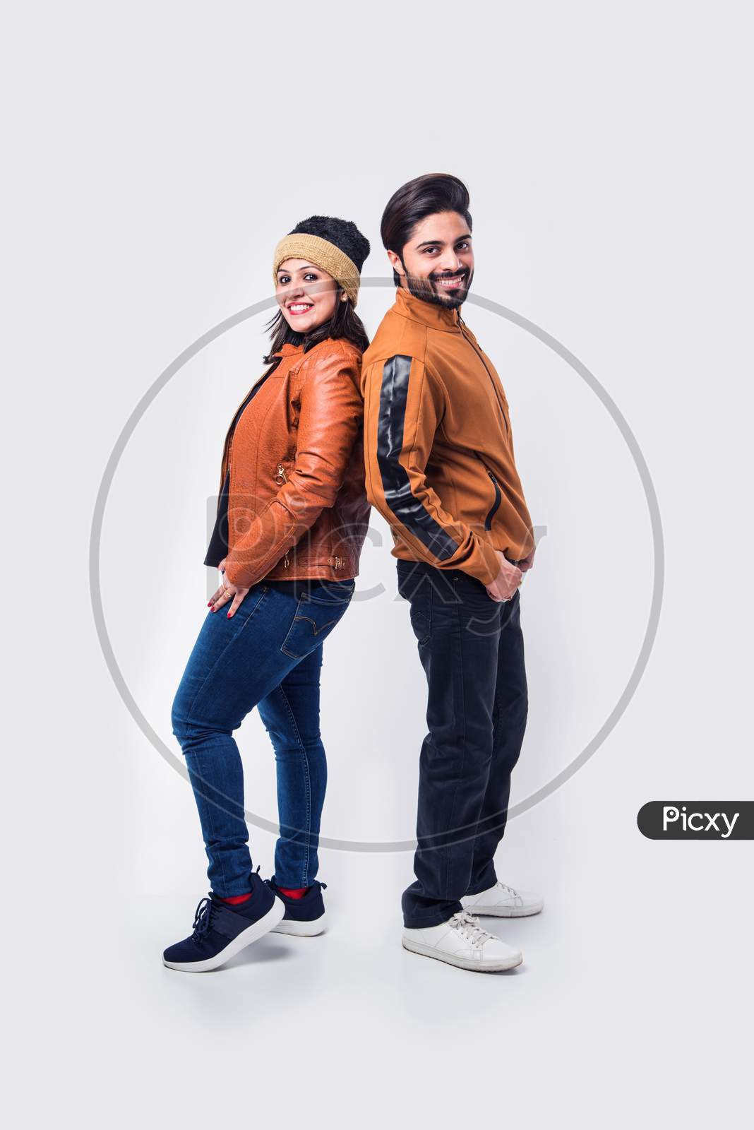 Indian young couple in winter wear /warm clothes against white background