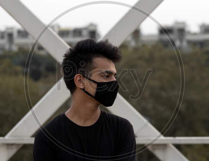 A Young Male Put A Mask On To Avoid Coronavirus Infection In A City.