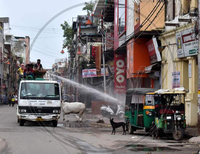 A municipal worker sprays disinfectant in a market during the lockdown to control the spread of Coronavirus in Prayagraj, Uttar Pradesh on July 12, 2020