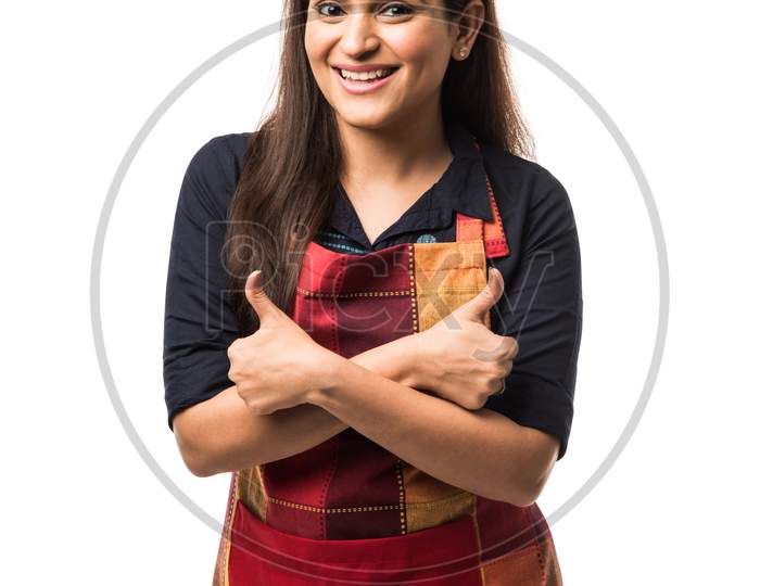 woman chef or cook in apron, presenting, pointing, with ok sign, thumbs up or hands folded
