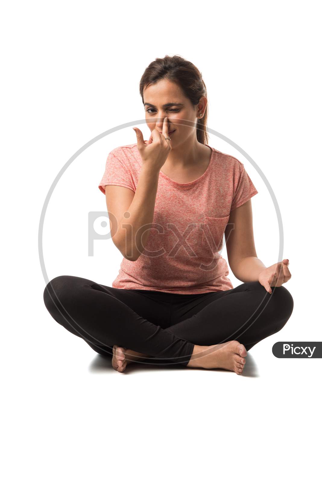 Indian Woman / Girl performing Yoga asana or meditation or dhyan, sitting isolated over white background