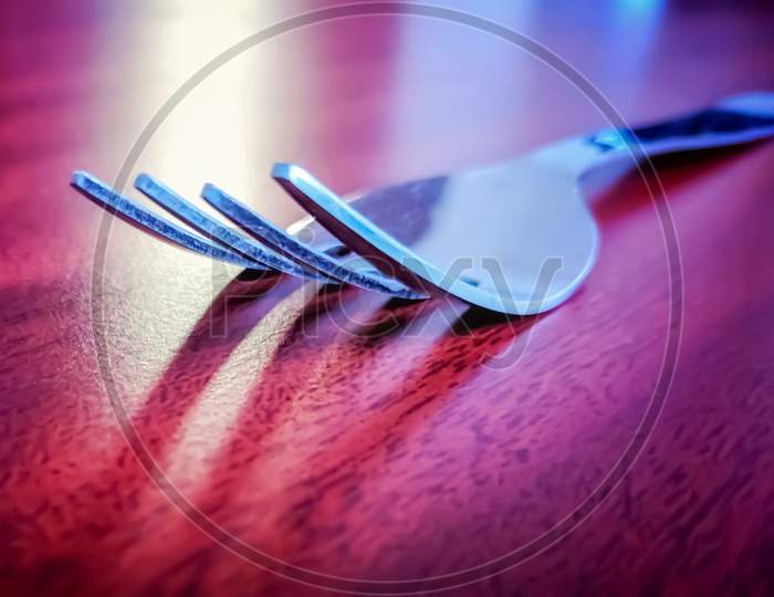 A Fork Shadow Reflecting On The Table