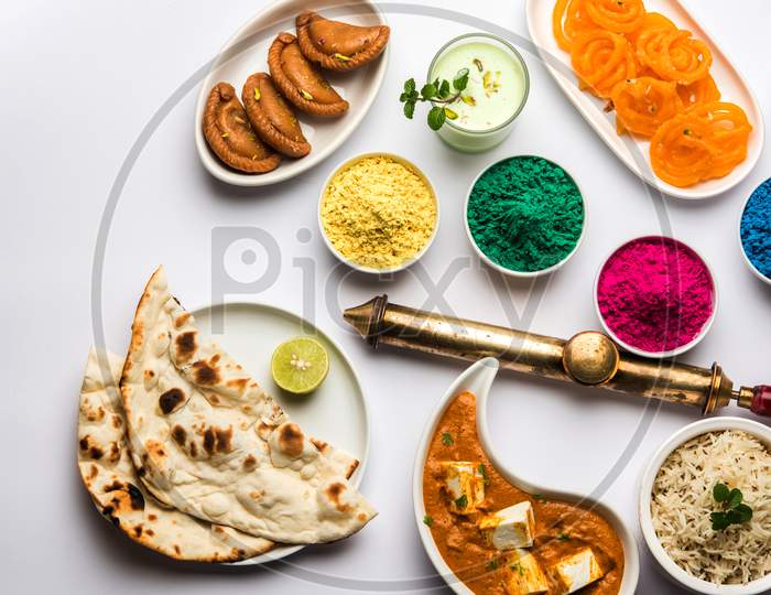 Happy Holi colours with Indian lunch food and sweet food or dessert