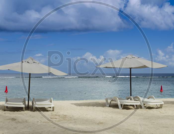 tropical beach with umbrellas and blue sky.