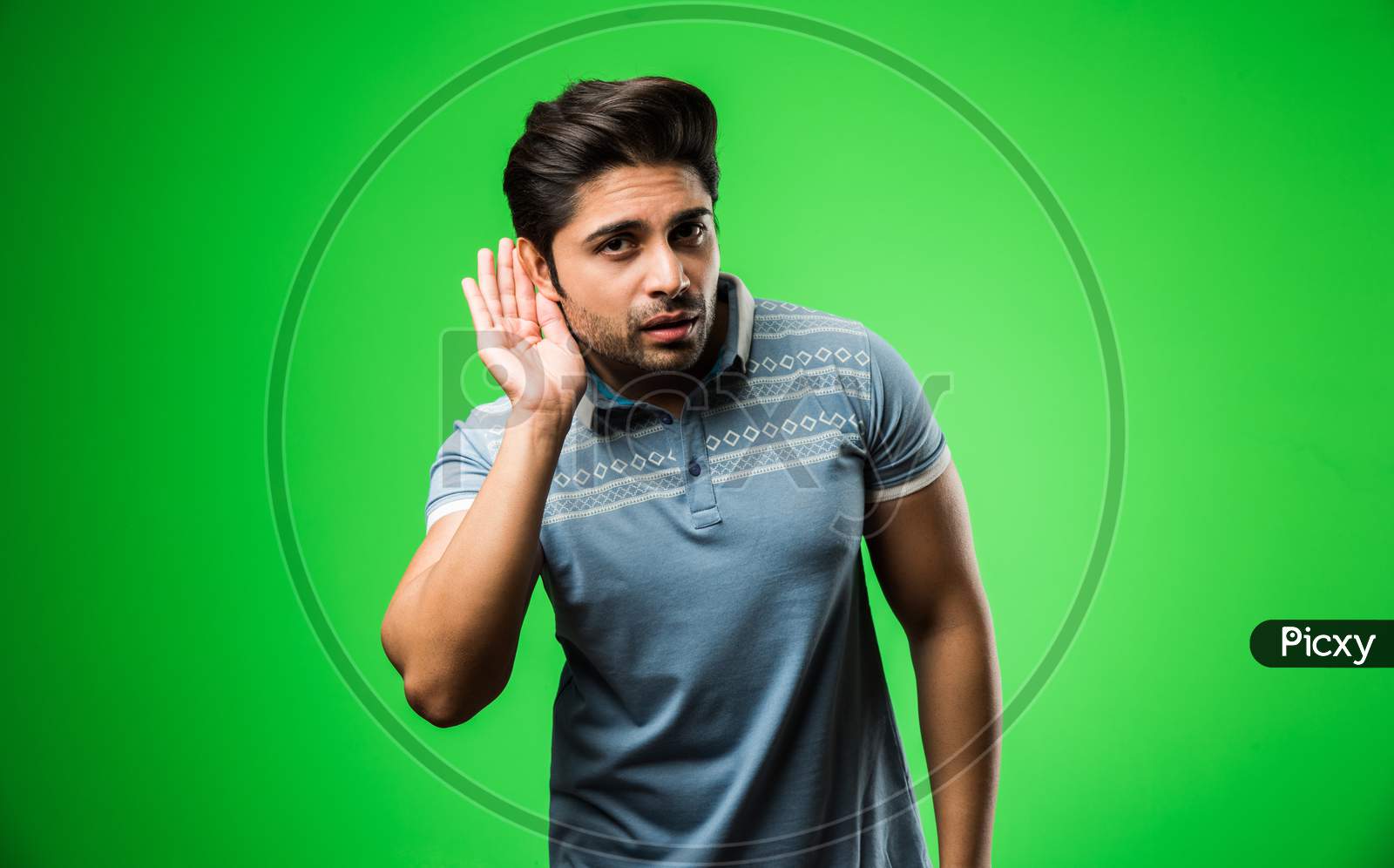 Indian Man Listening holding his hand near his ear, isolated over green background