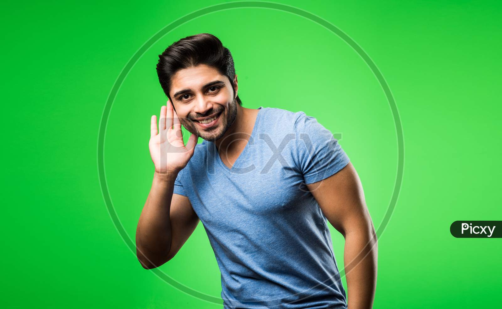 Indian Man Listening holding his hand near his ear, isolated over green background