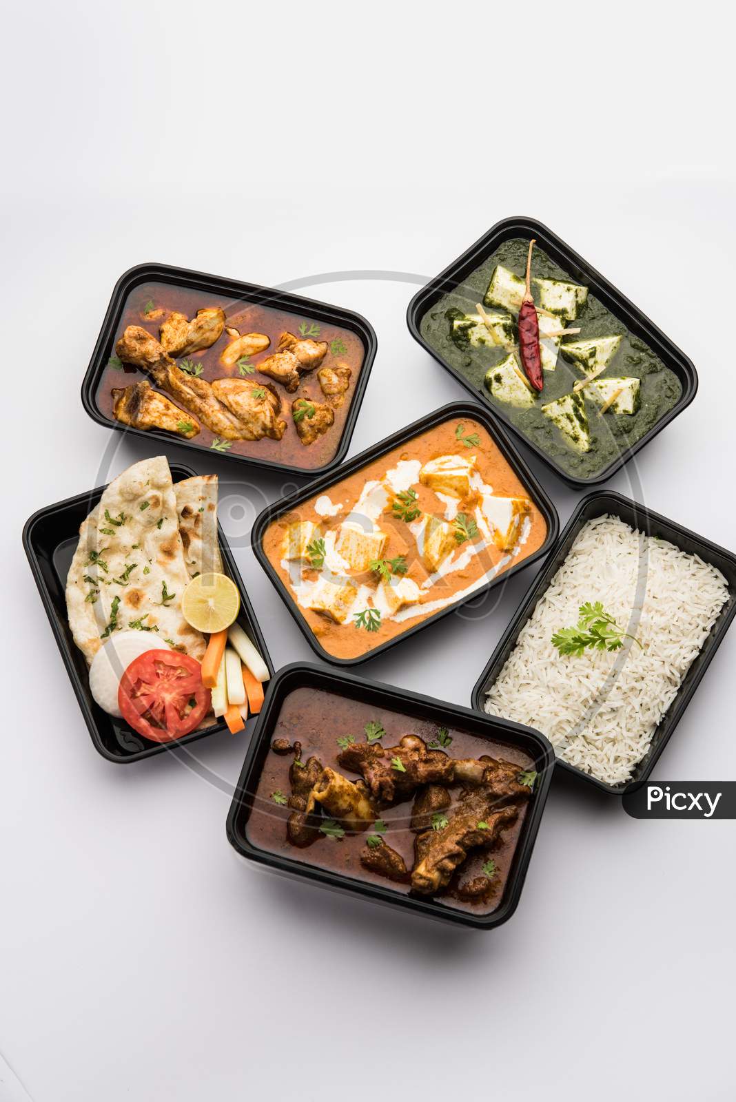 Online food delivery - Chicken & mutton curry with Palak Paneer Butter masala packed in plastic container
