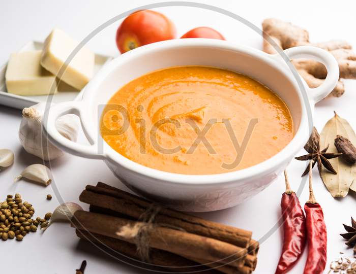 North Indian basic Curry for paneer butter masala or chicken makhanwala recipe shown with ingredients, served in a bowl. selecti
